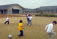 Students dribbling soccer balls