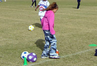 Student dribbling a soccer ball