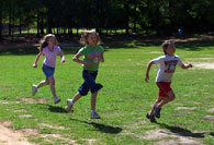 Students running around field