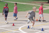 Children running between cones